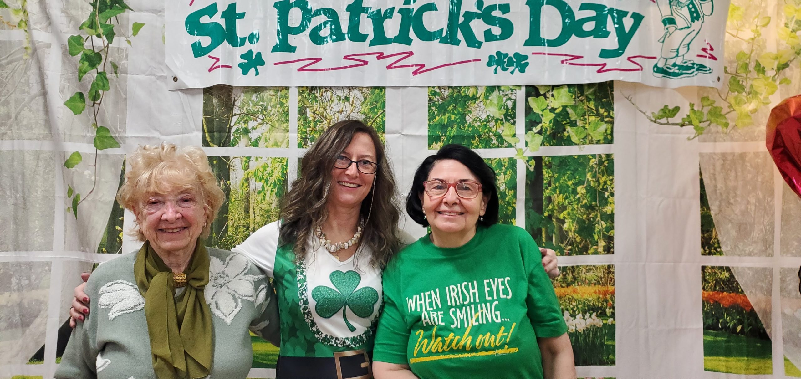 residents and staff member of pete mcguinness older adult center dressed in green to celebrate saint patrick's day