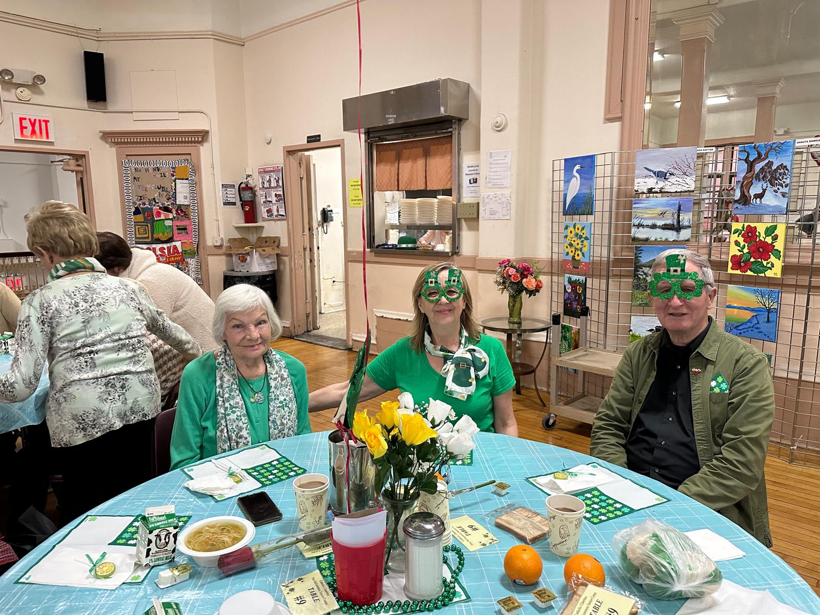 residents dressed in green with green glasses celebrating saint patrick's day