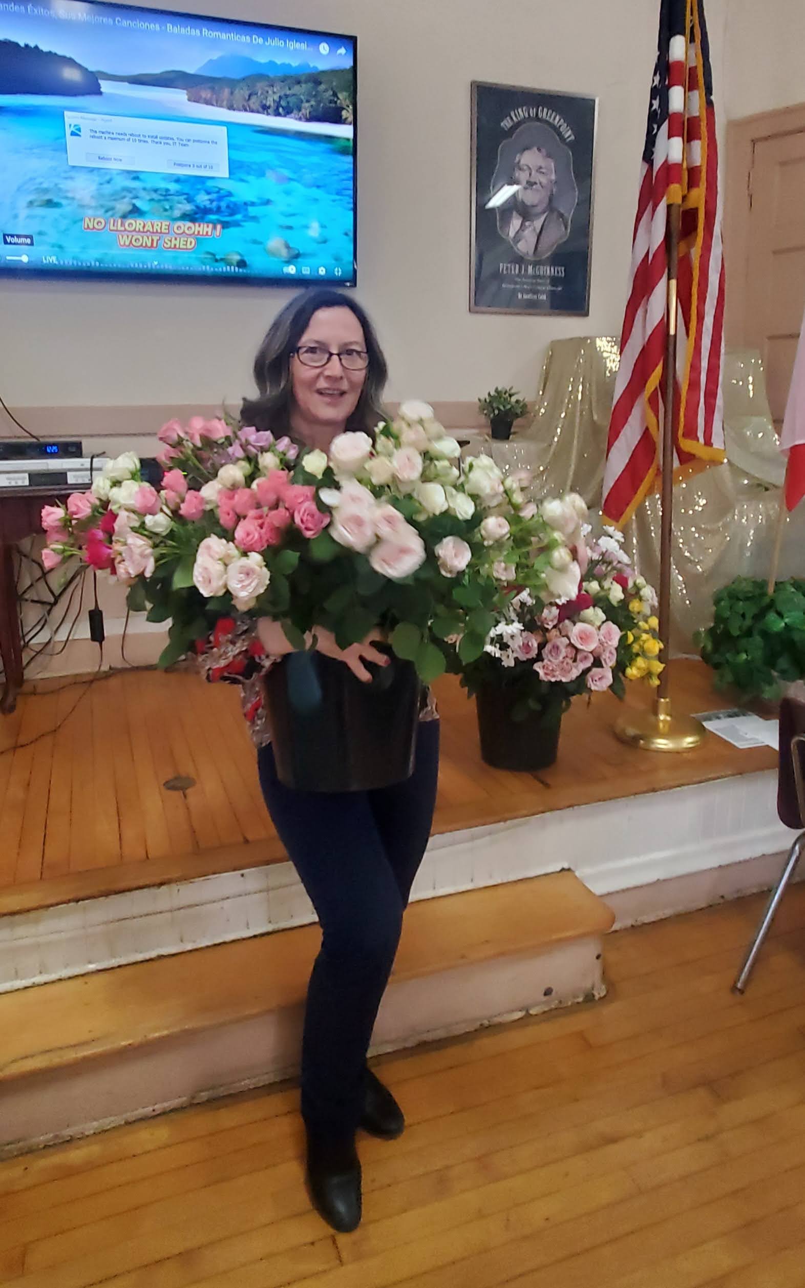A Staff member is holding a big flower bouquet of roses for international women's day