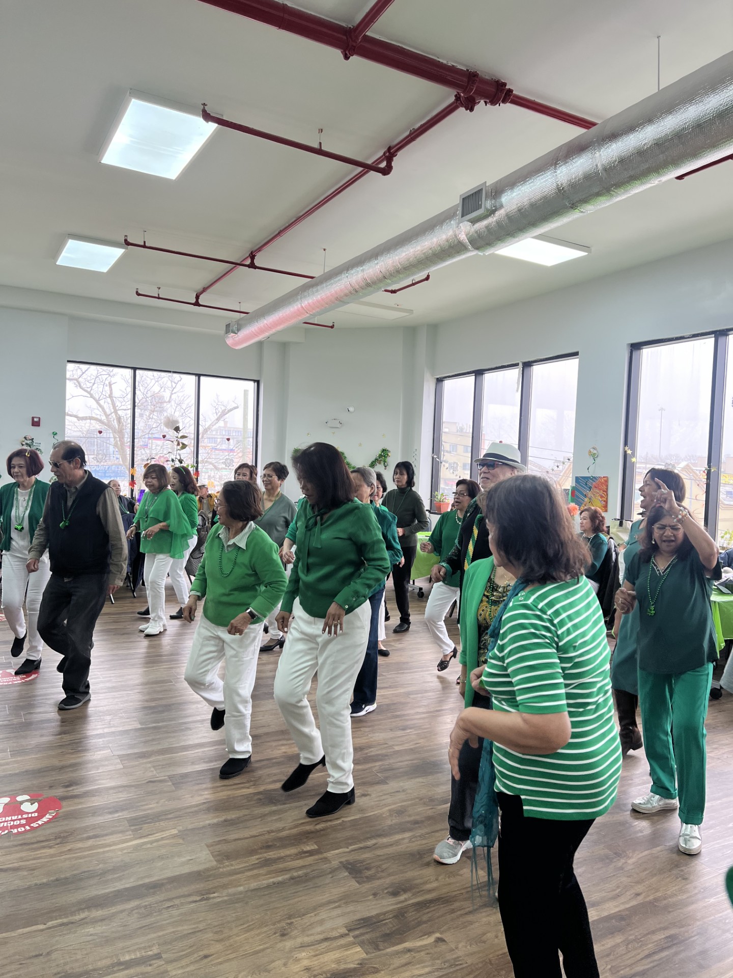 residents of the hillcrest older adult center dancing and dressed in green to celebrate saint patrick's day