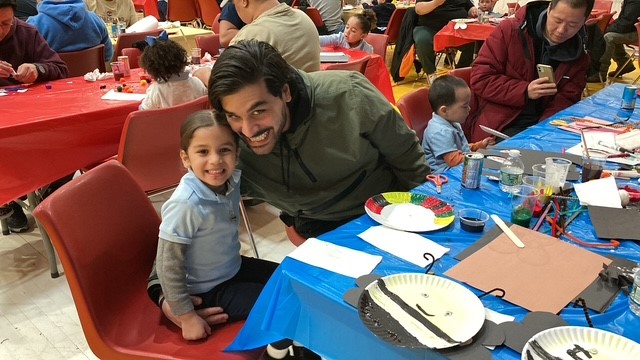 father and daughter smiling during the spring insect art activities