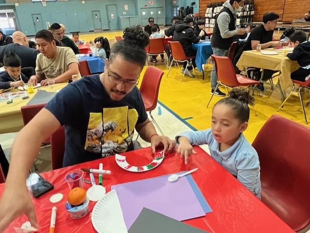 father and daughter crafting during the spring insect art activities