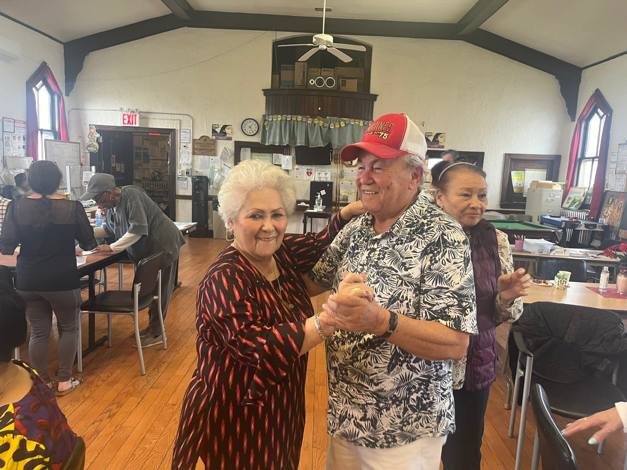 an older couple dancing during the mrch birthday celebration at seaside older adult center