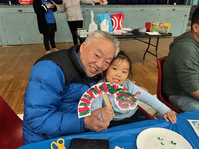 grandfather and granddaughter showing their insect art
