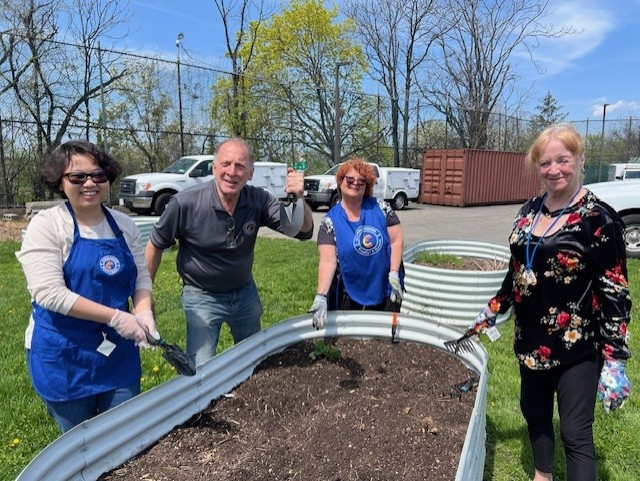 outreach team gardening in howard beach for earth day