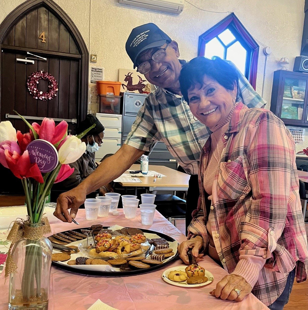 two older adults at the food table celebrating older americans month at seaside older adult center