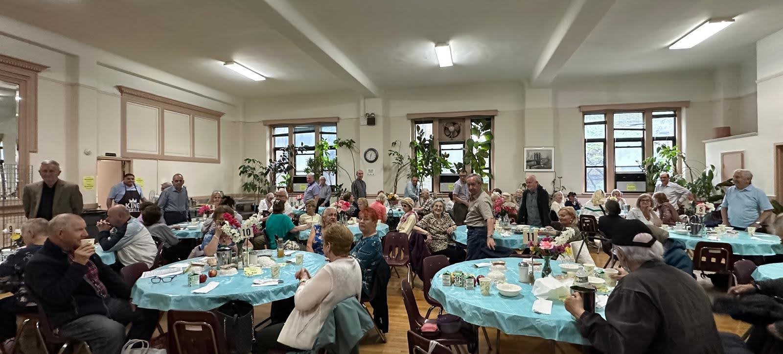 residents with their families and friends celebrating father's day at pete mcguinness older adult center