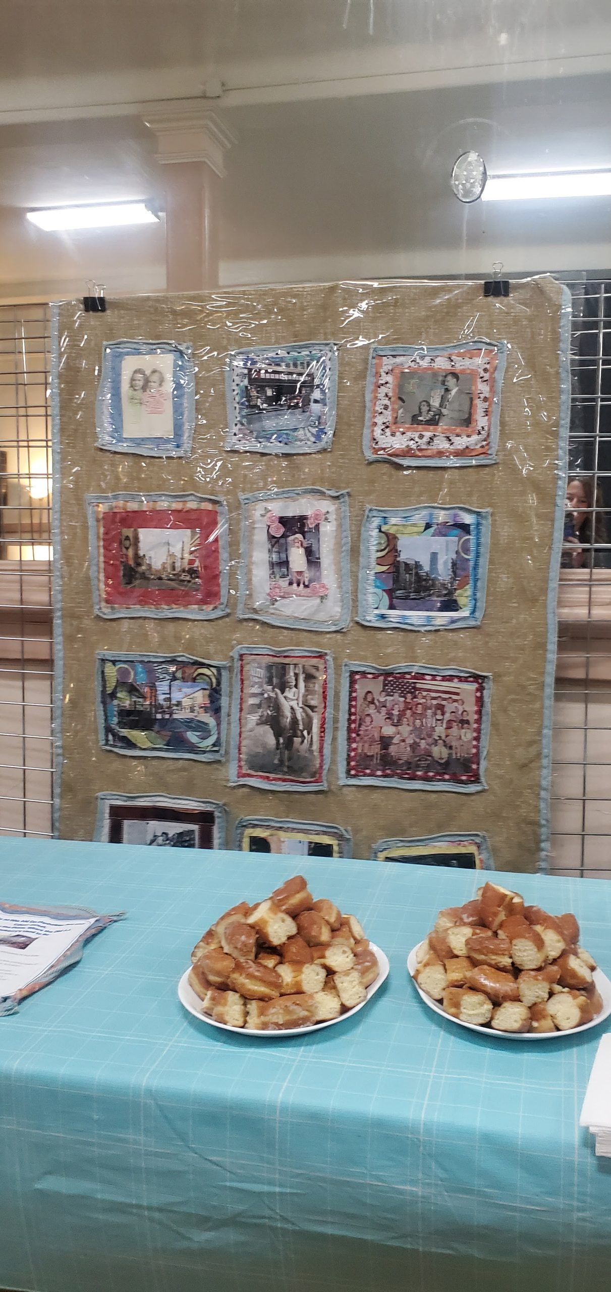 view of the neighborhood photo quilt collaborative project and a table with donuts