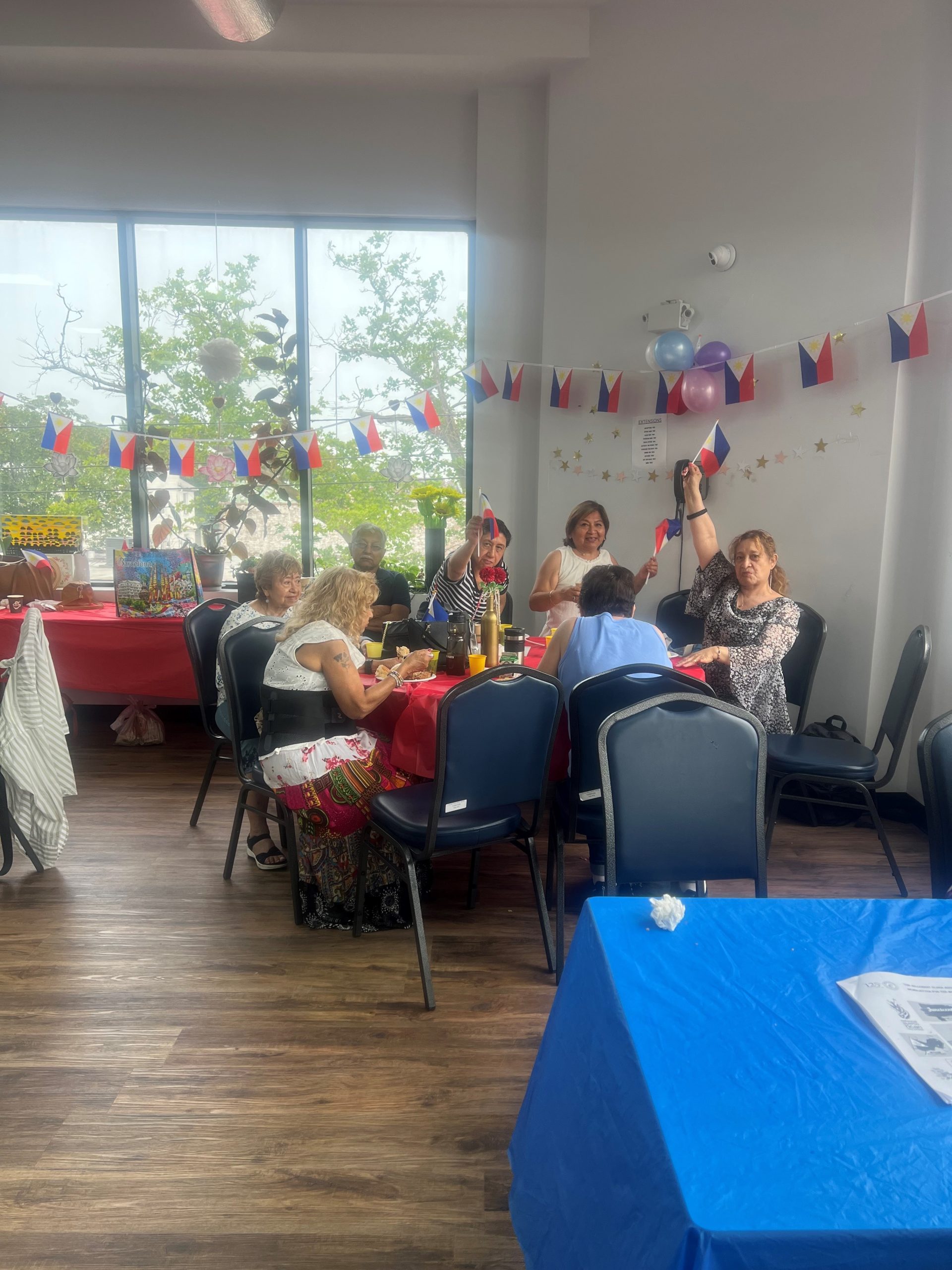 Hillcrest Older Adult residents having lunch at a table and celebrating philippines independence day