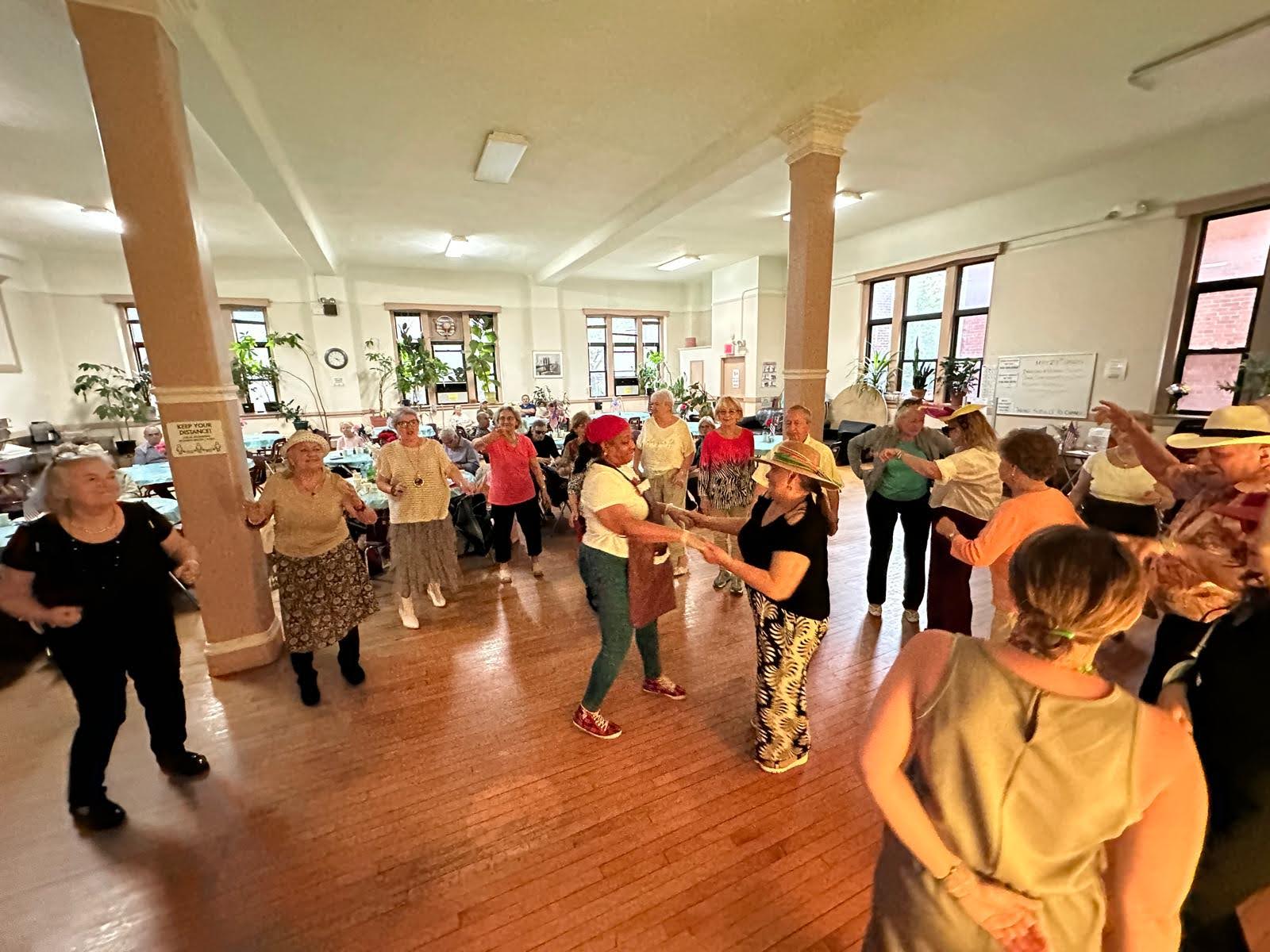 the senior residents are dancing celebrating older americans month