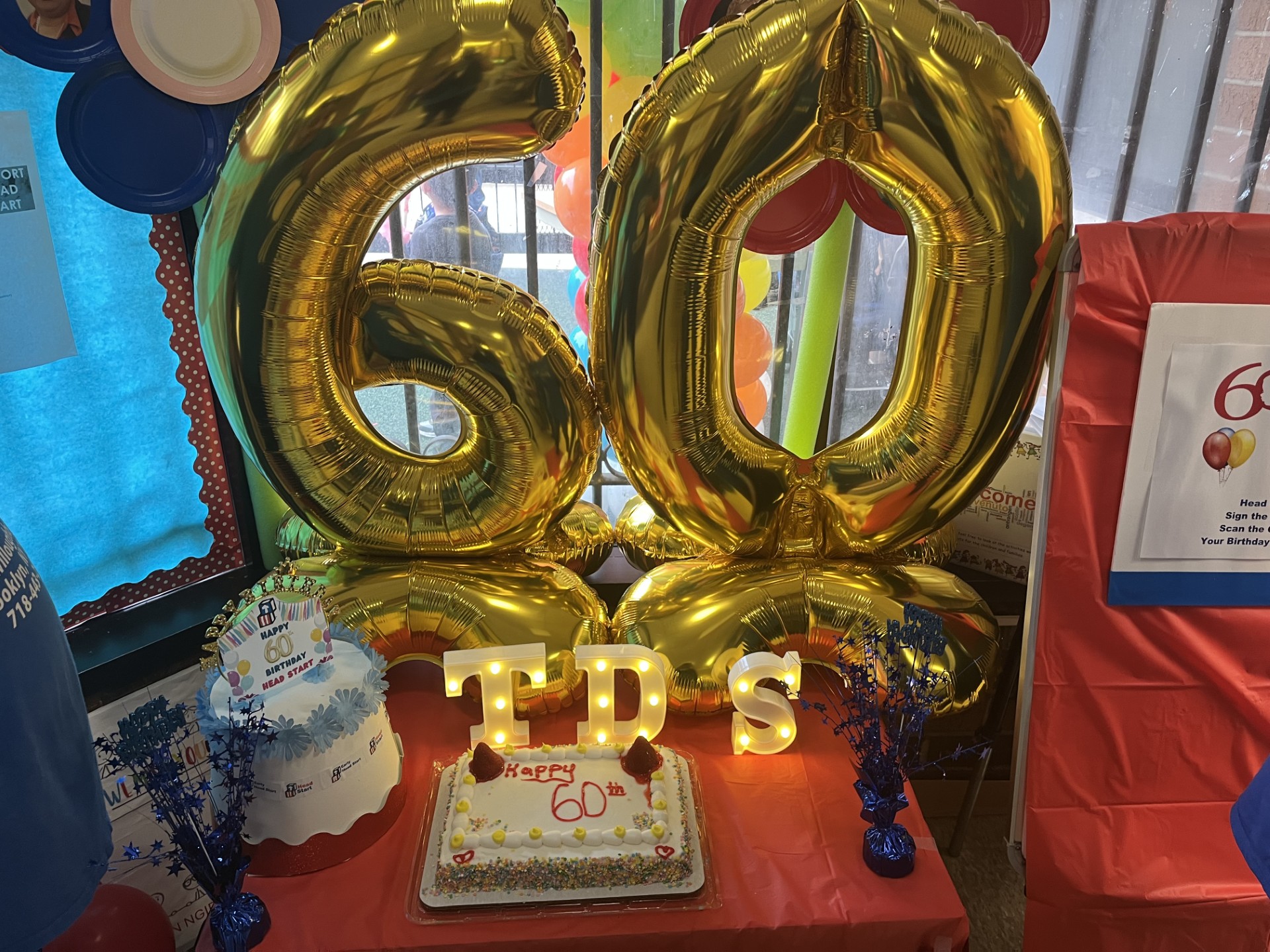 Big balloons with the number sixty and two cakes to celebrate sixty years of Head Start