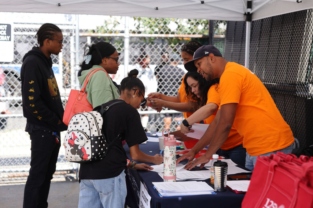 families filling information at the catholic charities booth during the annual family fun day