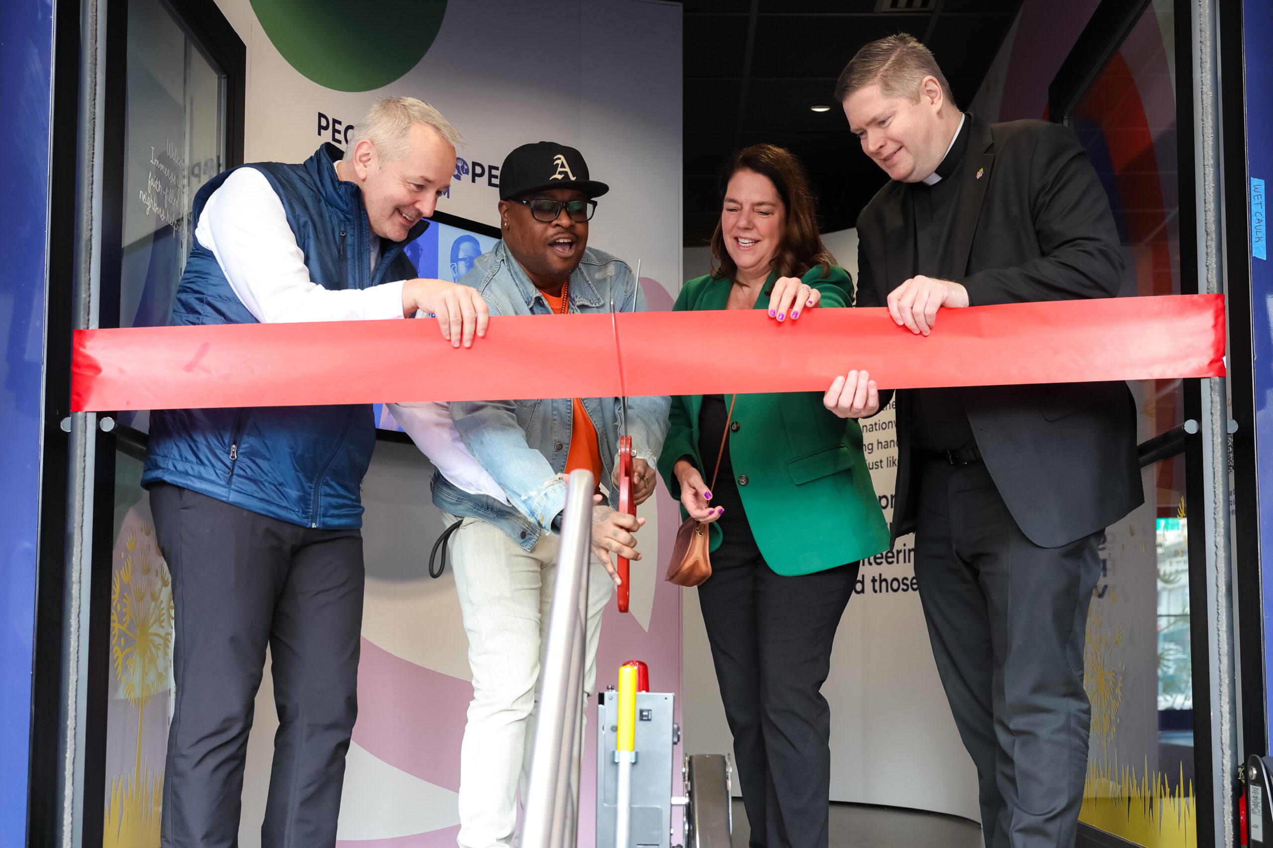 cutting the ribbon From the left:  J. Antonio Fernández, CEO of Catholic Charities Archdiocese of New York; Jamar Carr, a substance abuse counselor at Catholic Charities Brooklyn and Queens; CCUSA President and CEO Kerry Alys Robinson; and Very Rev. Patrick J. Keating, deputy CEO of Catholic Charities Brooklyn & Queens. (Photo by Matthew Adam)